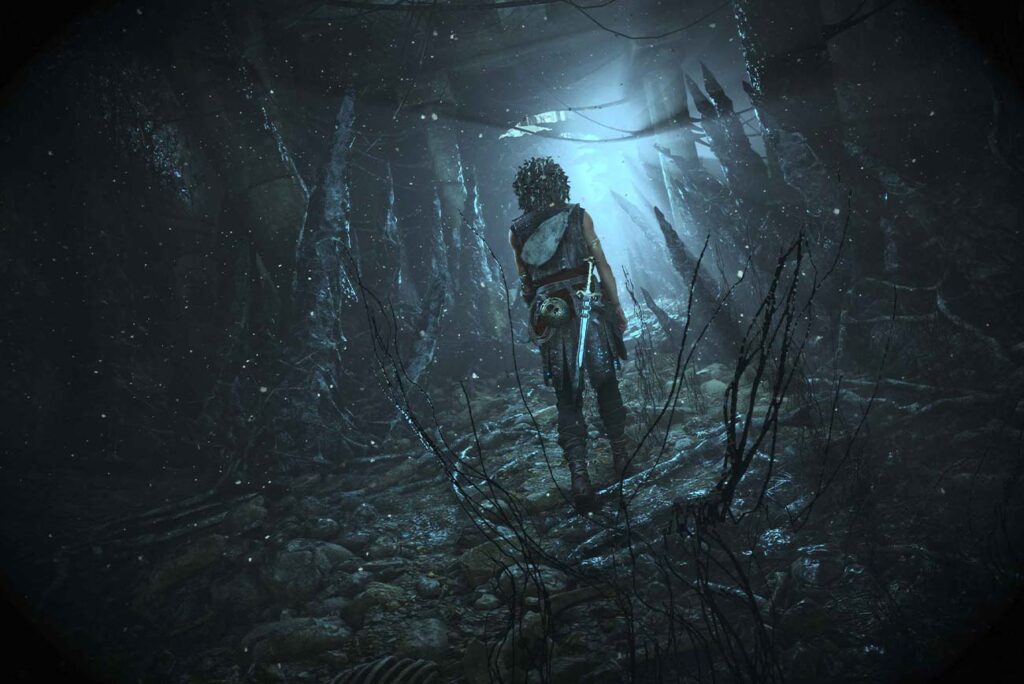 Sophia, protagonista di Resonance: A Plague Tale Legacy, di spalle, che cammina verso l'unica luce di un antro oscuro